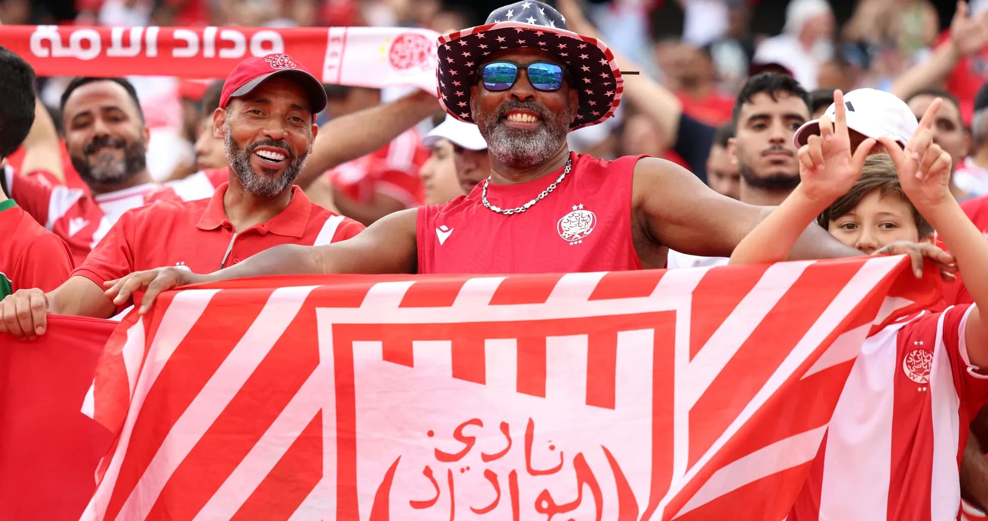 Fans celebrating with flag at football match