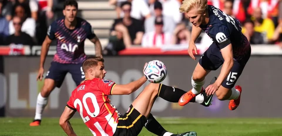 Player tackling another during a football match