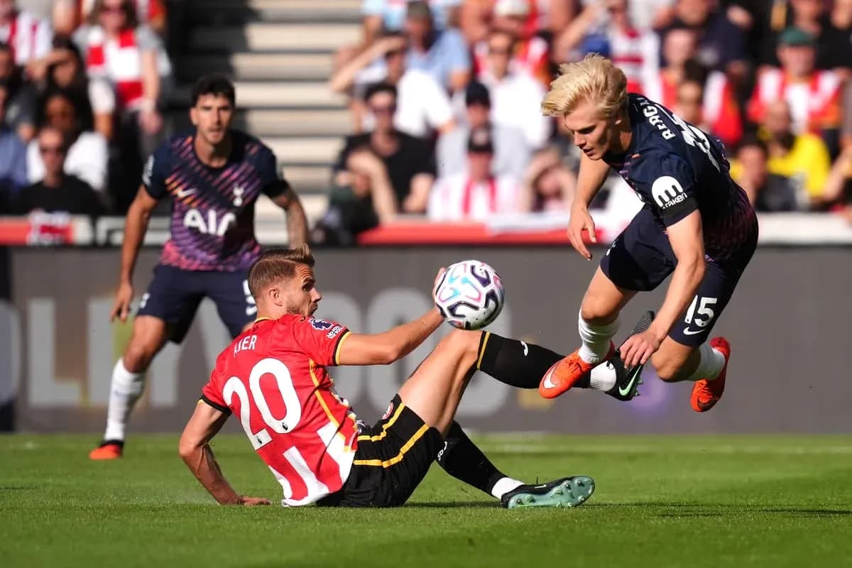 Player tackling another during a football match