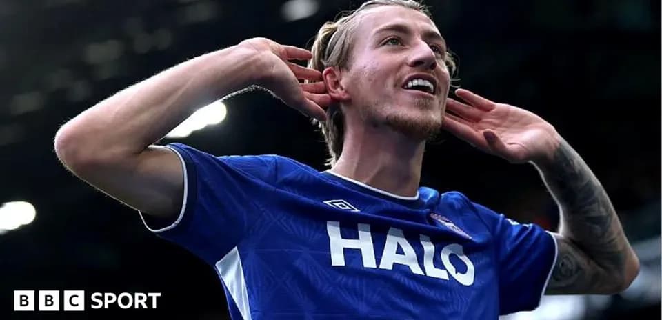 Player celebrating a goal with hands to ears
