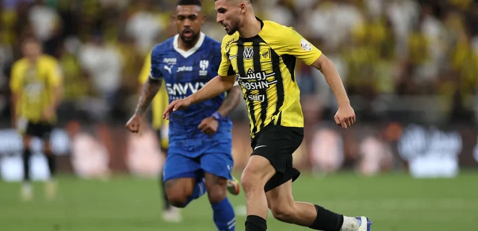 Player in yellow dribbling past opponent in blue