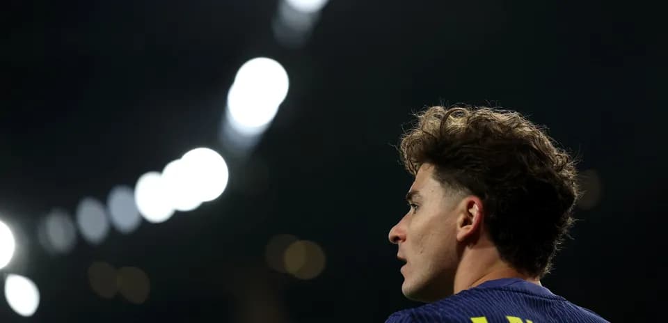 Player J. Alvarez in focus with stadium lights