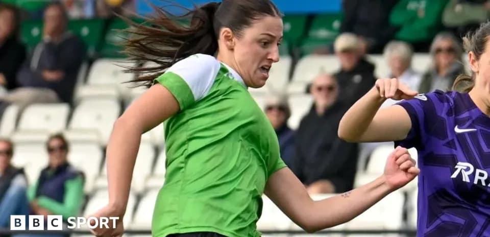 Player in green dribbling the ball during match