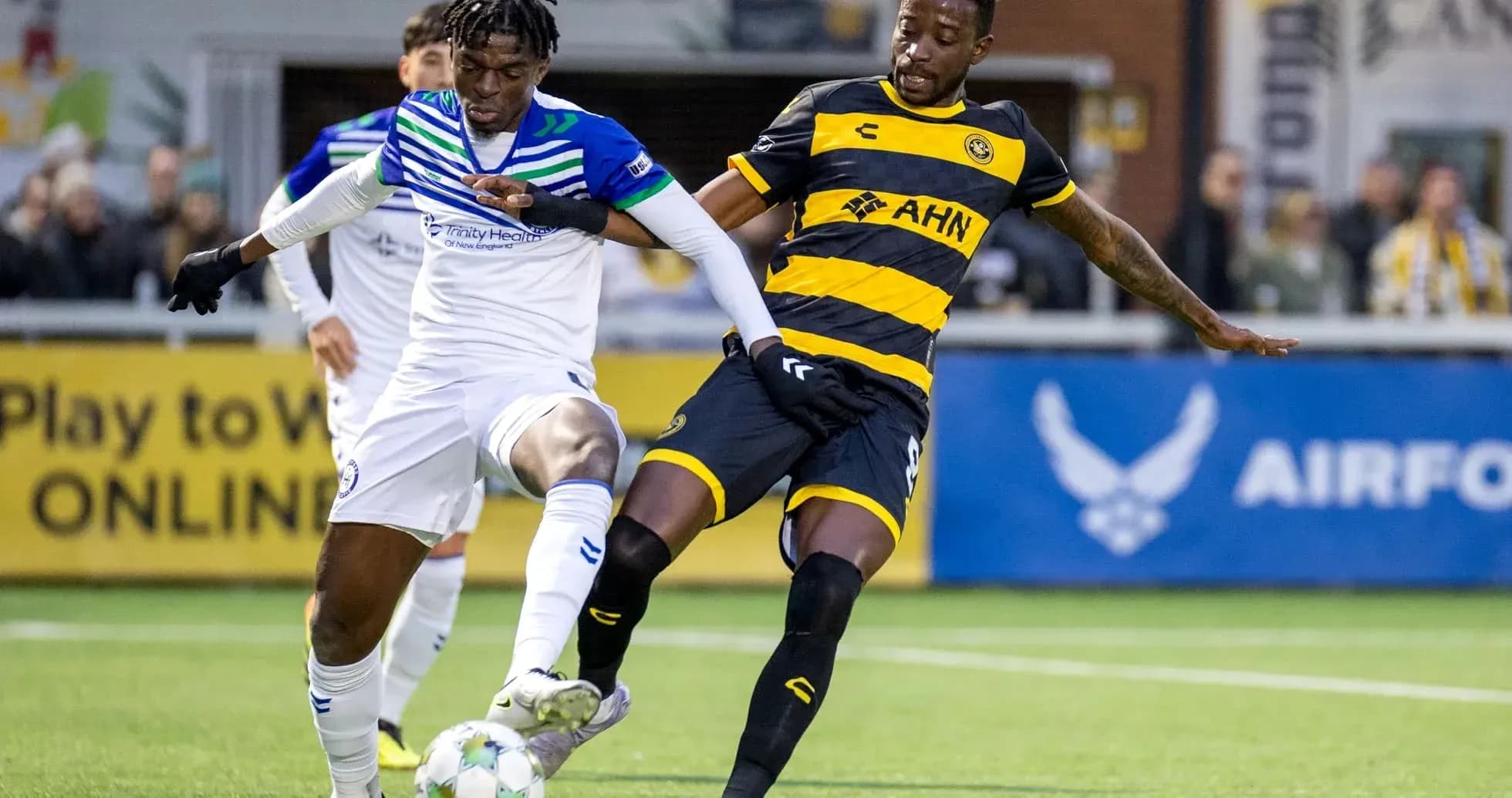Players competing for the ball in USL Championship