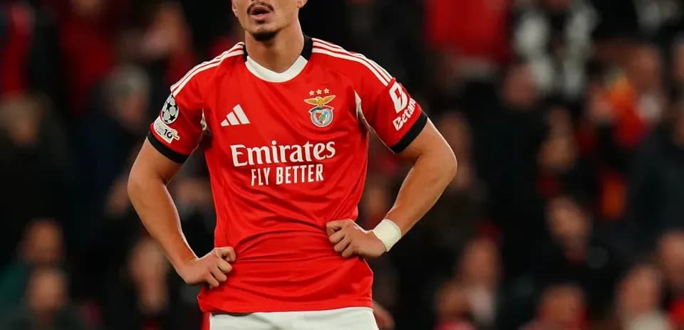 Player in Benfica kit standing with hands on hips