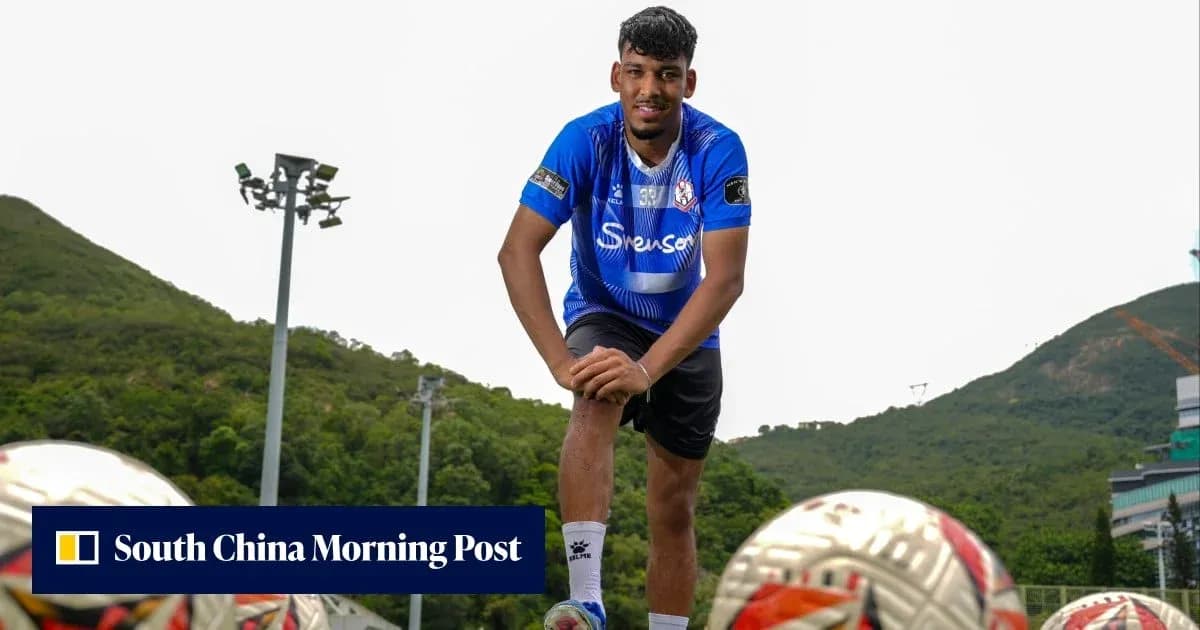 Player posing with footballs at training ground
