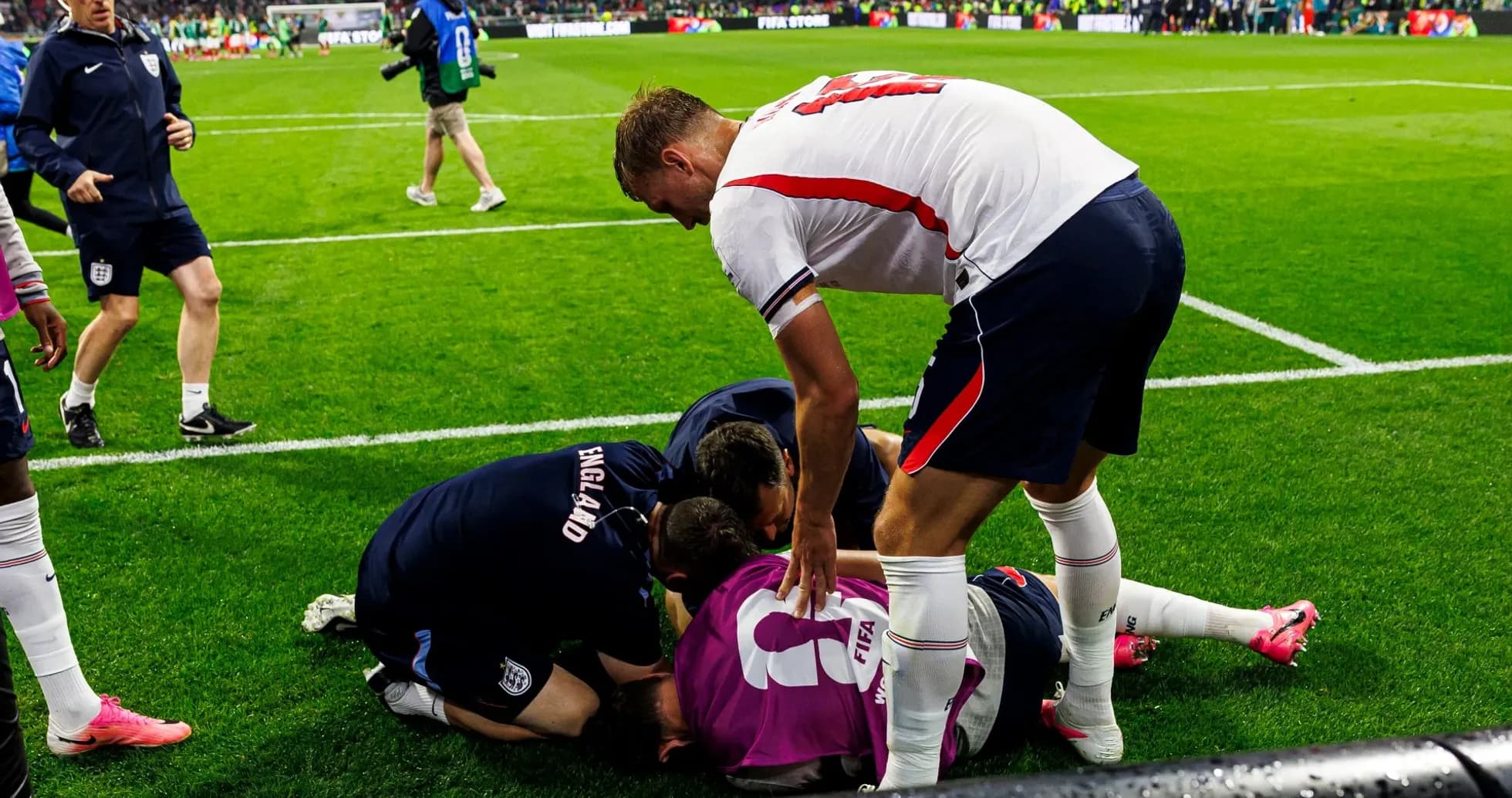 Team members assisting injured player on the field