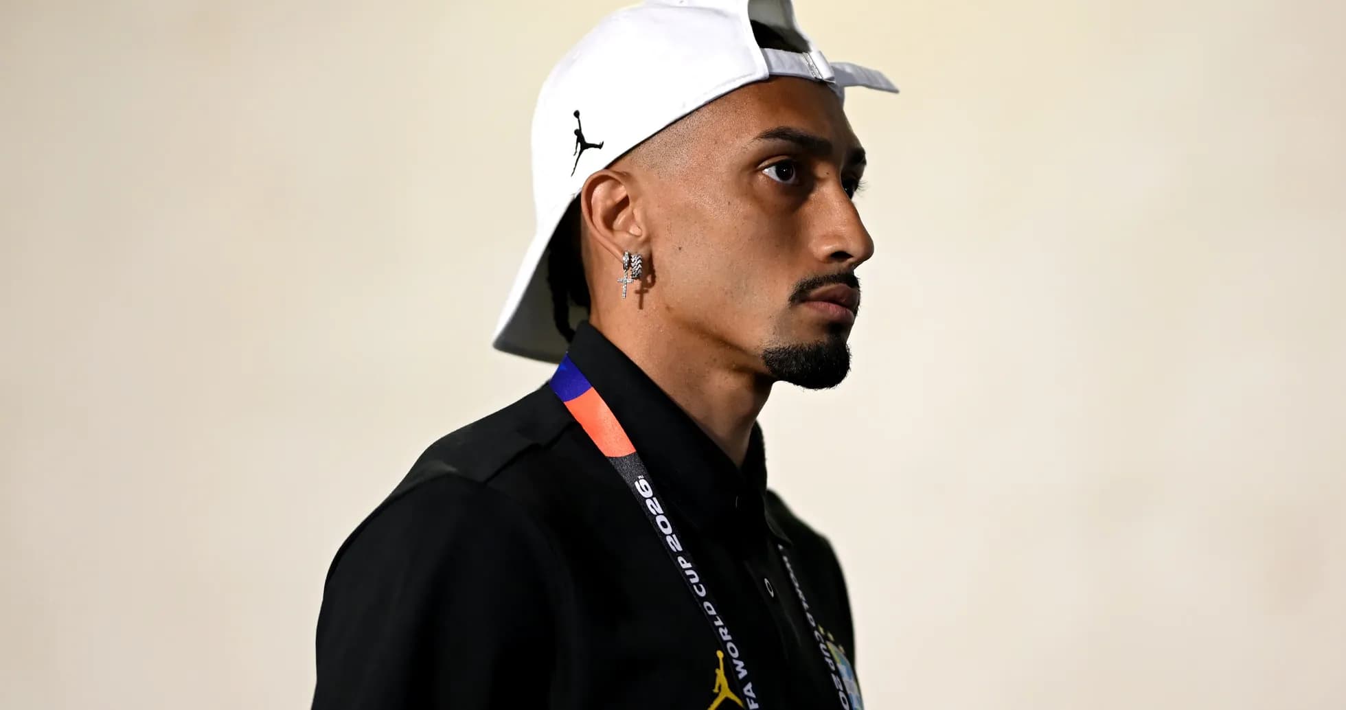 Player wearing a cap and lanyard in profile