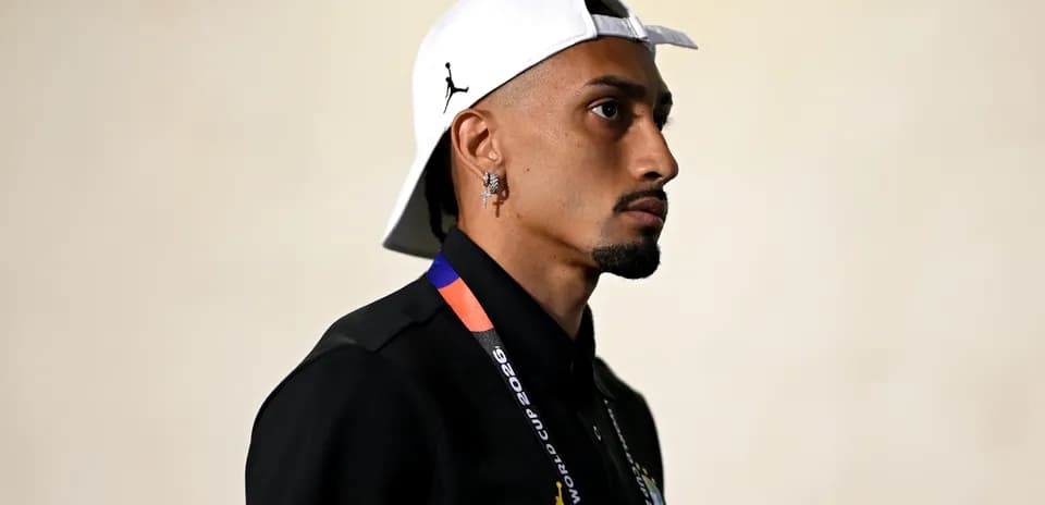 Player wearing a cap and lanyard in profile