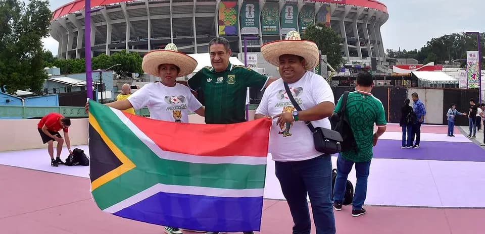 Fans holding South African flag outside stadium