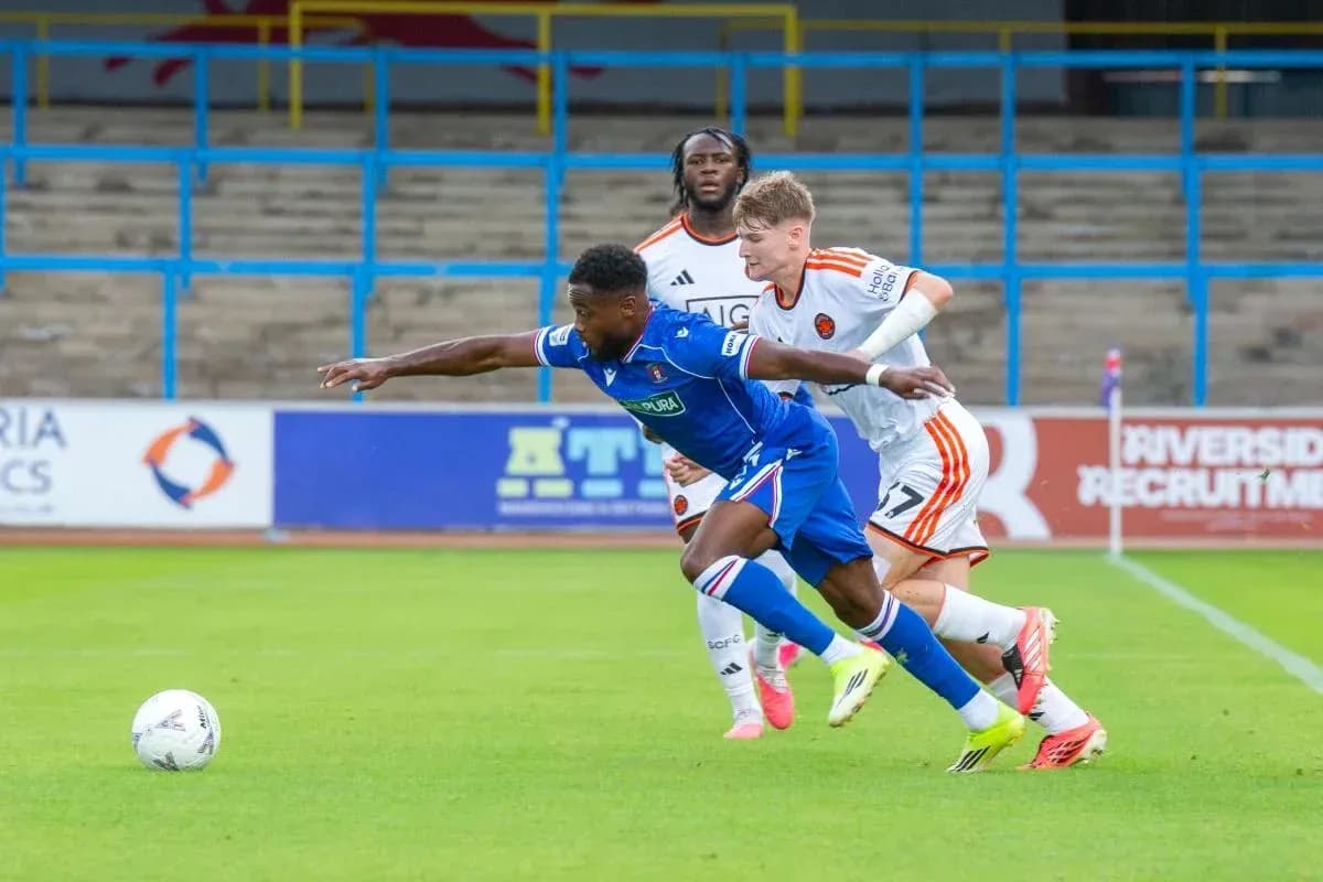 Player in blue shirt falling while being challenged