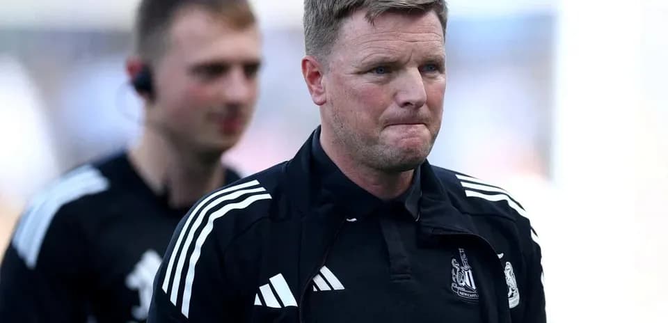 Manager walking off pitch with team staff