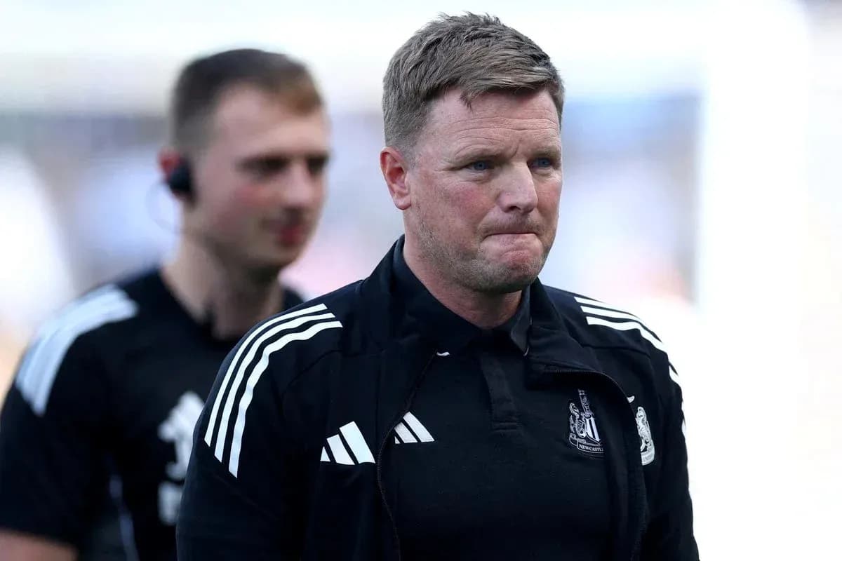 Manager walking off pitch with team staff