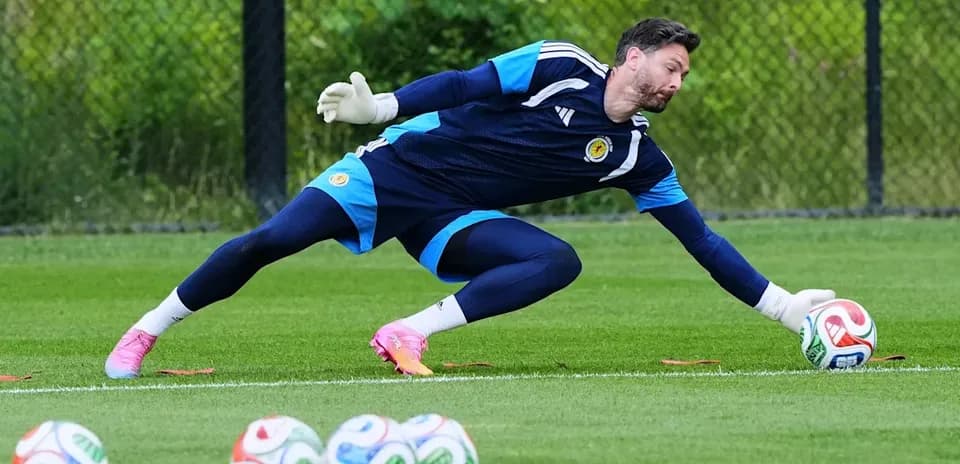 Goalkeeper diving to save a soccer ball during practice