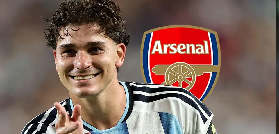 Player celebrating with Arsenal logo in background