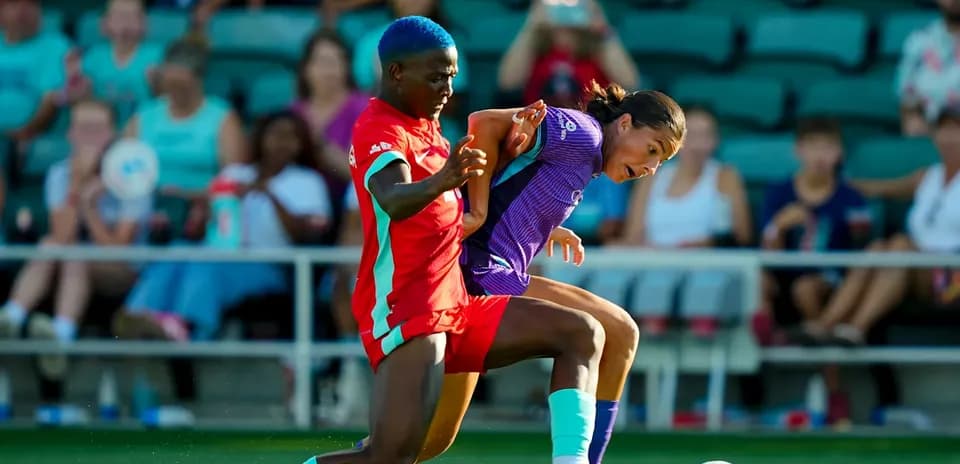 Player tackling opponent during Kansas City vs Orlando match