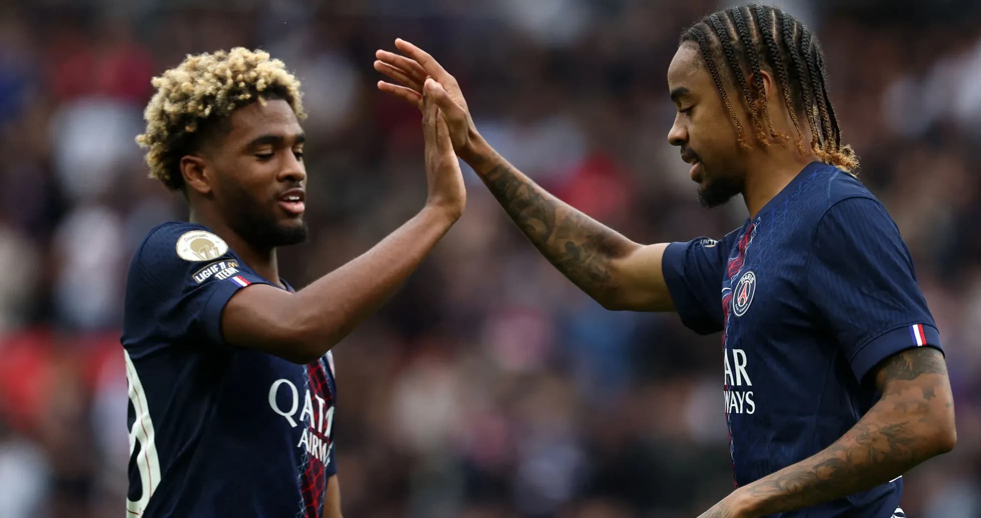 Two Paris Saint-Germain players celebrating a goal