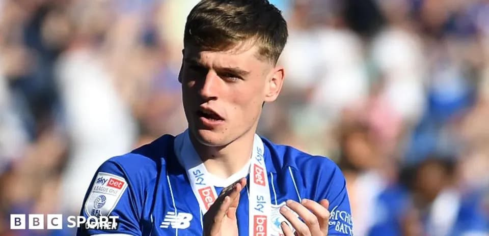 Player applauding with medal at stadium