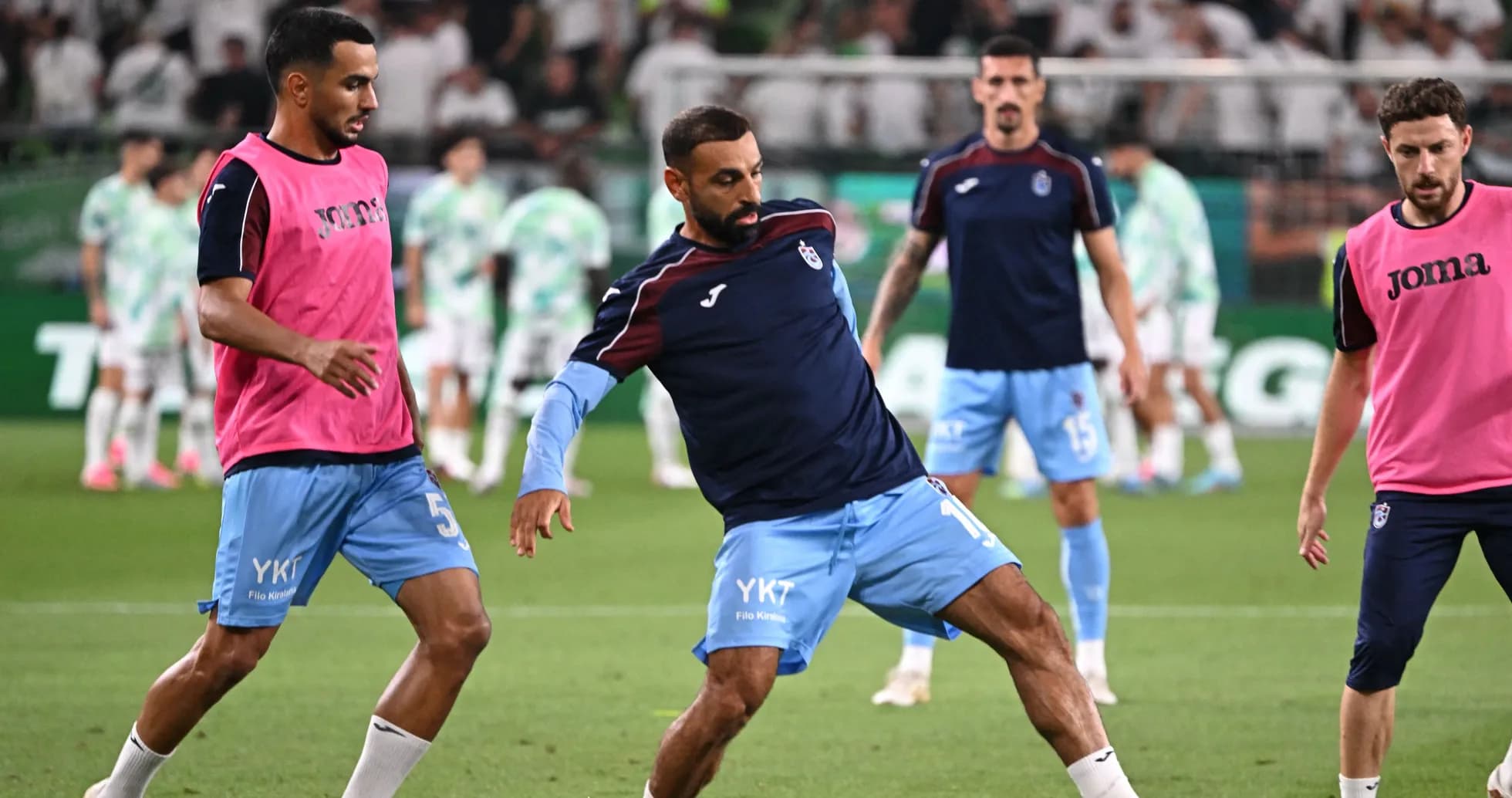 Players warming up on the pitch before match
