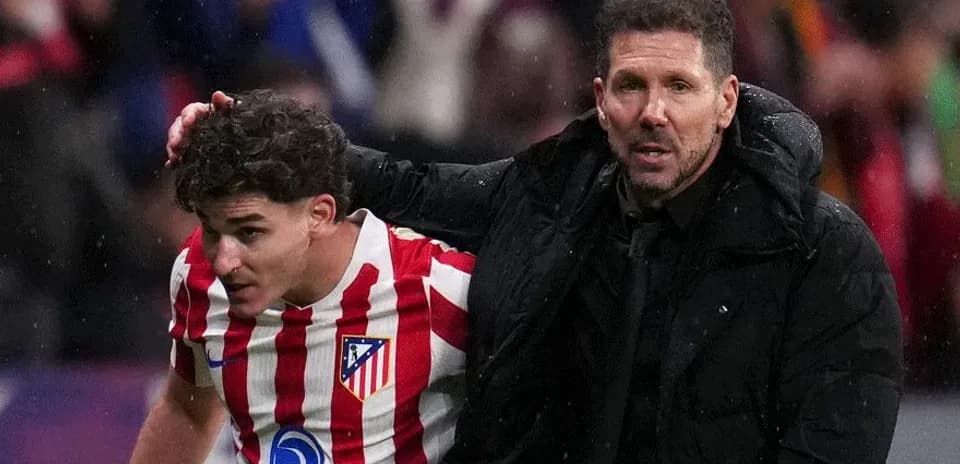 Atletico Madrid player being assisted by manager