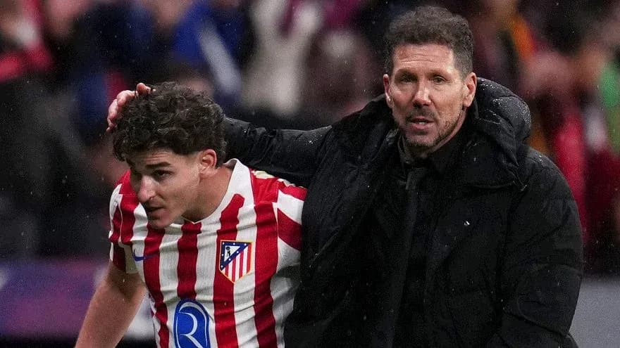 Atletico Madrid player being assisted by manager