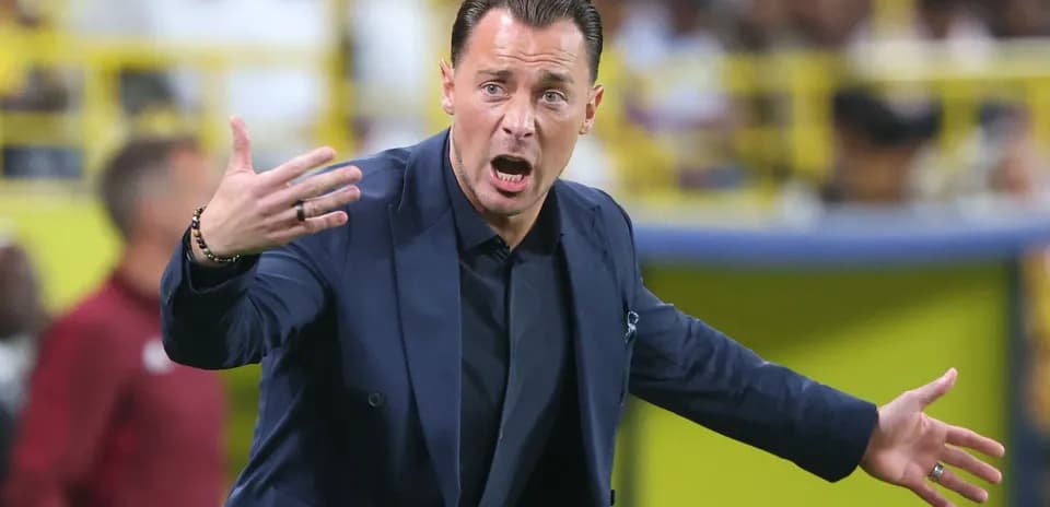Coach gesturing during a match from the sidelines