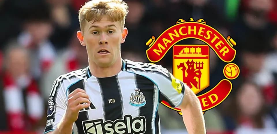 Newcastle player running with Manchester United logo in background