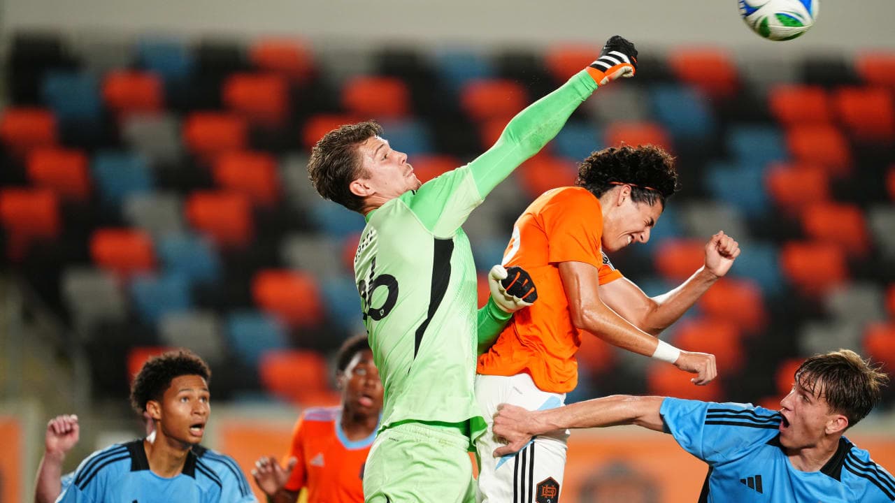 Goalkeeper punching the ball during match