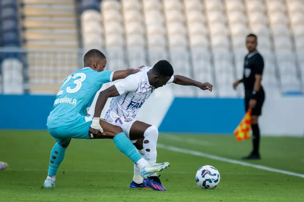 Goalkeeper challenges forward during U23 match
