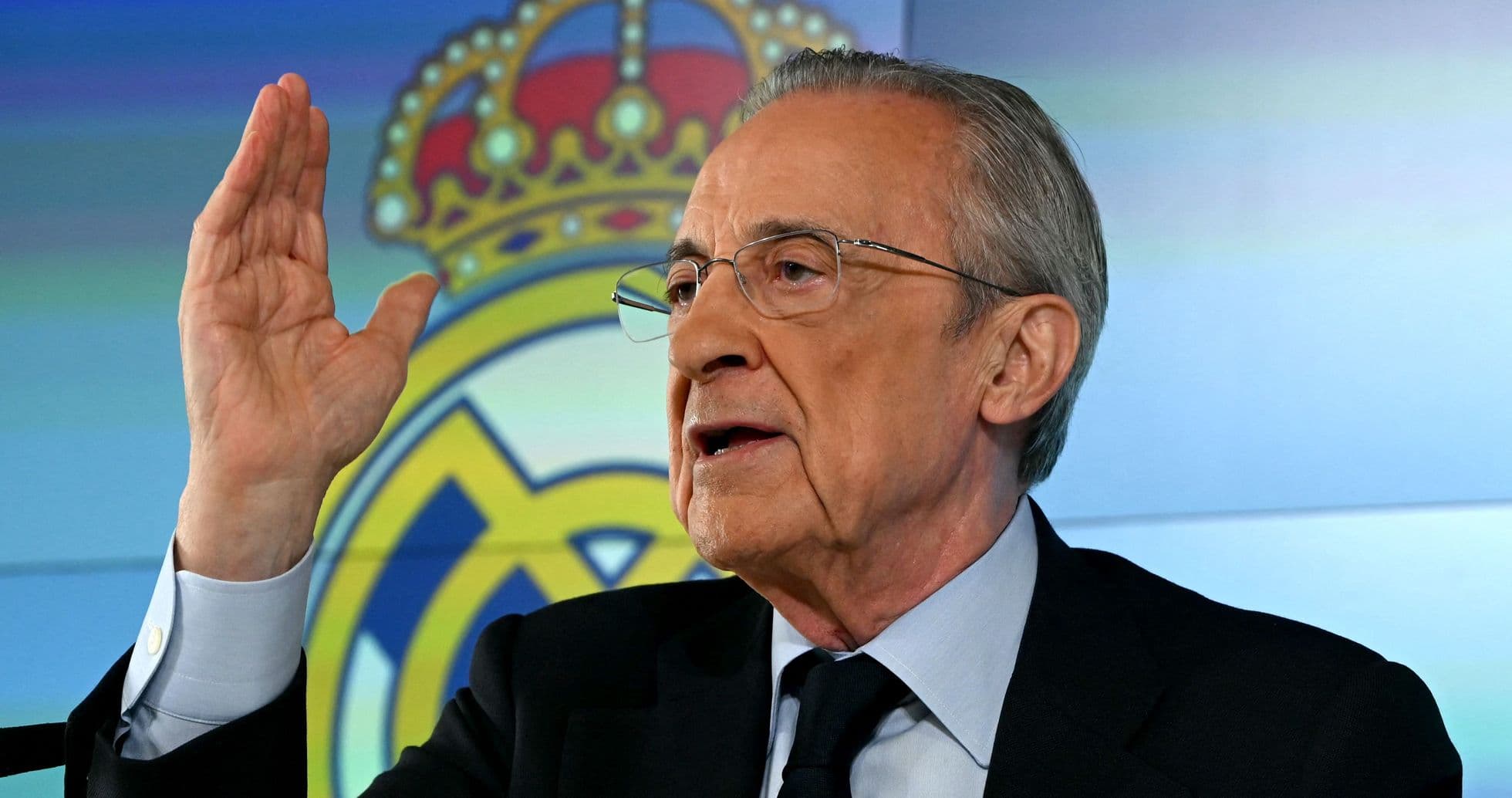Man gesturing while speaking at press conference