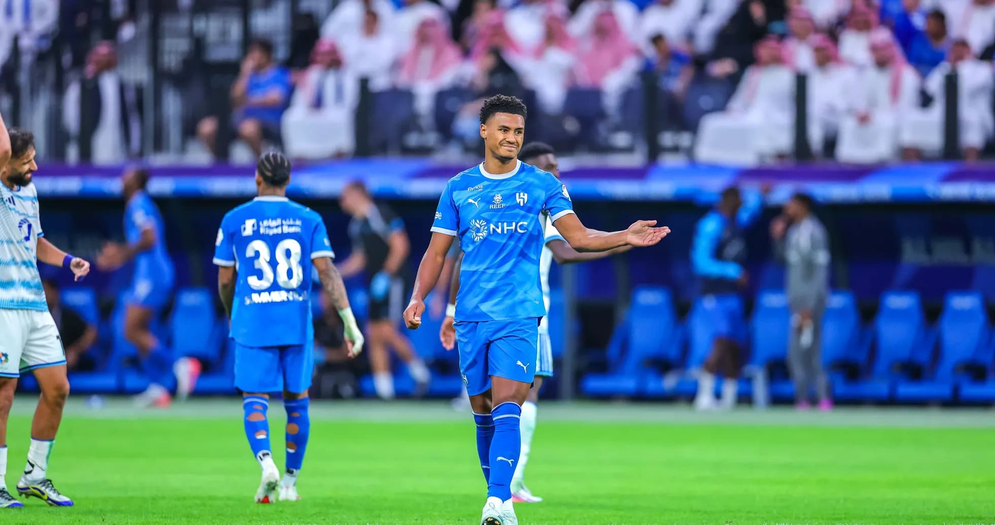 Player in blue jersey gesturing during match