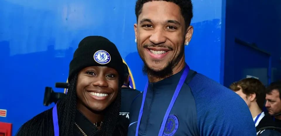 Two Chelsea fans posing for a photo together