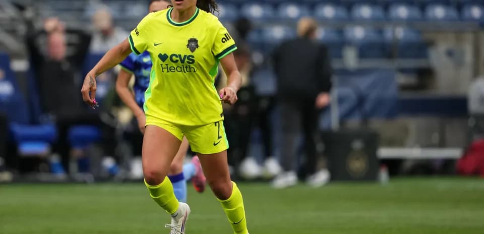 Player in green jersey dribbling the ball