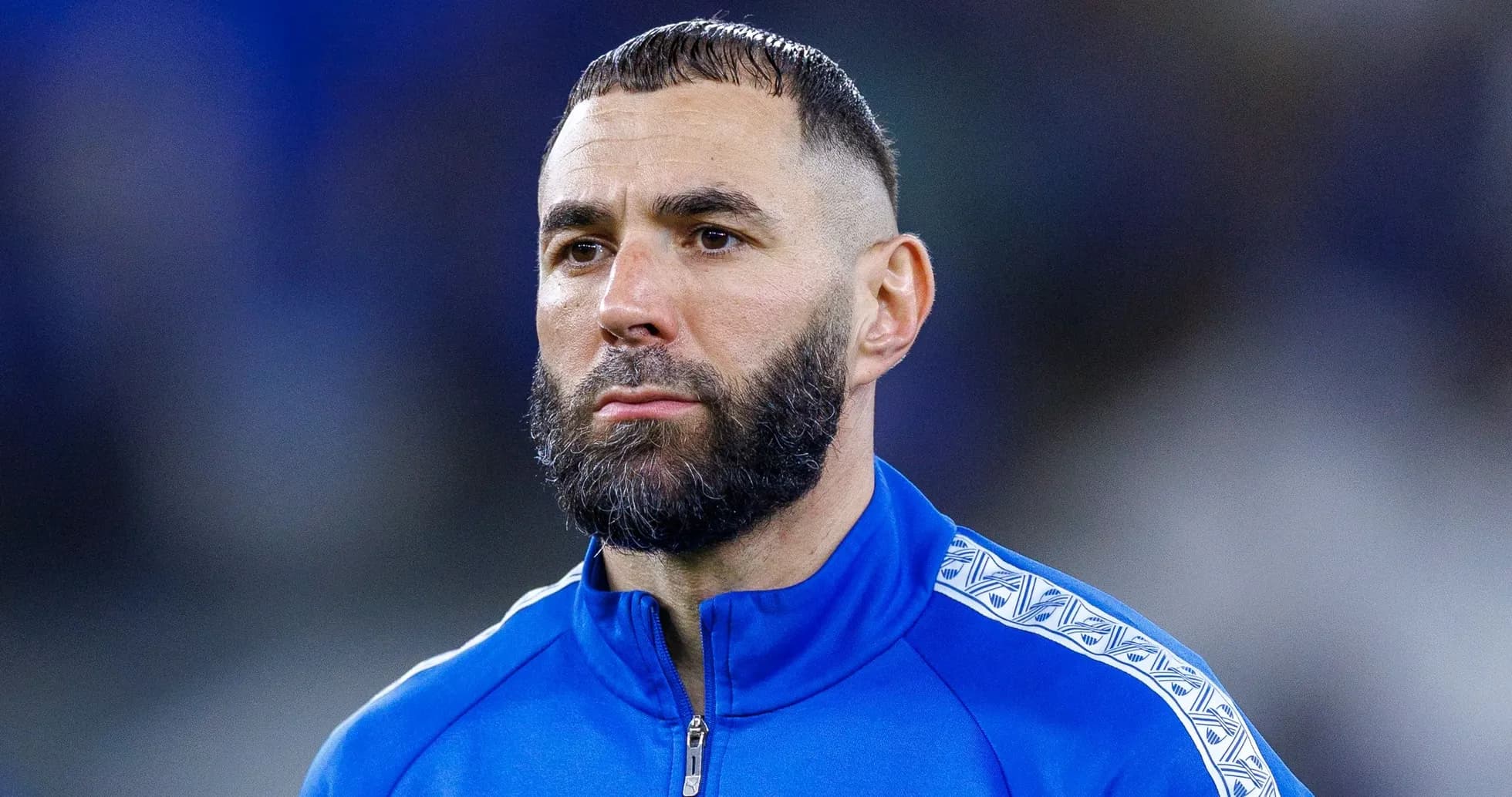 Player in blue tracksuit during match preparation