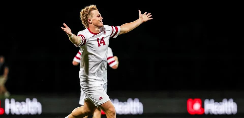 Soccer player celebrating with arms outstretched