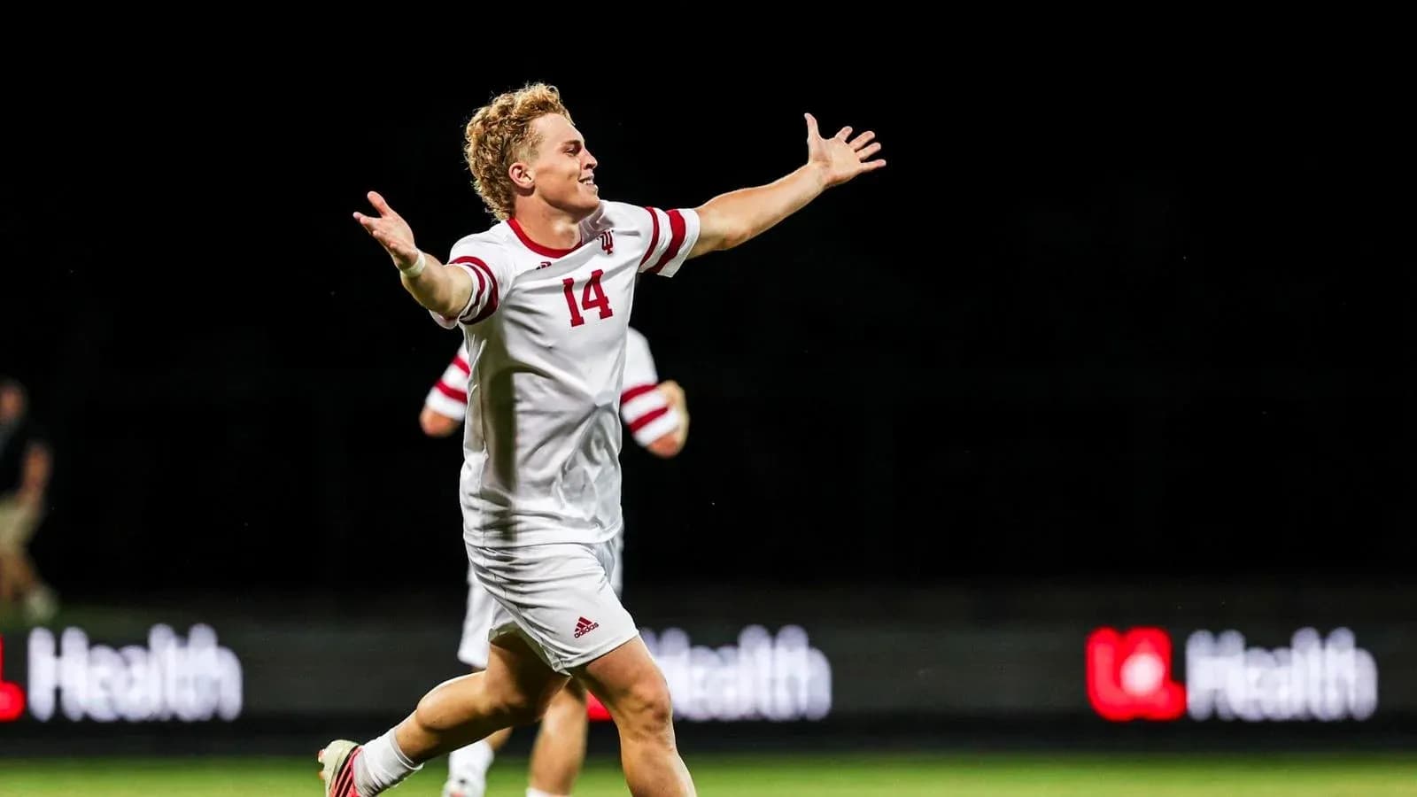 Soccer player celebrating with arms outstretched
