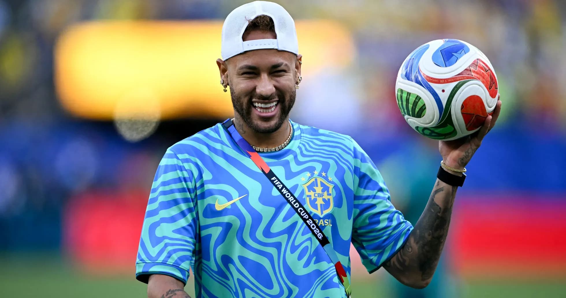 Player holding a soccer ball during warm-up