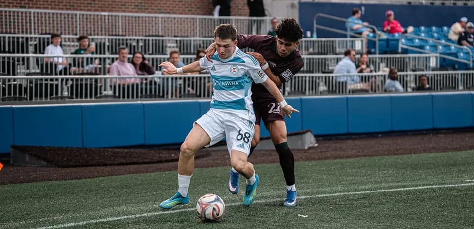 Player tackling opponent during MLS Next Pro match