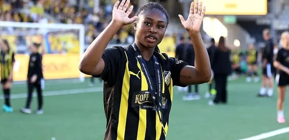 Player waving with hands on football pitch