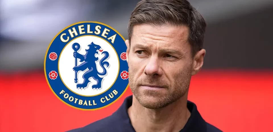 Man in navy shirt near Chelsea FC logo
