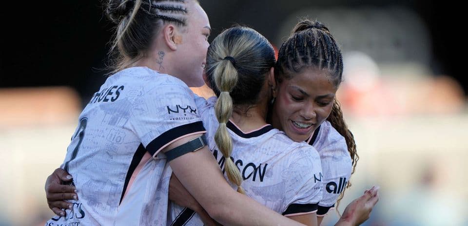 Players celebrating a goal during NWSL match