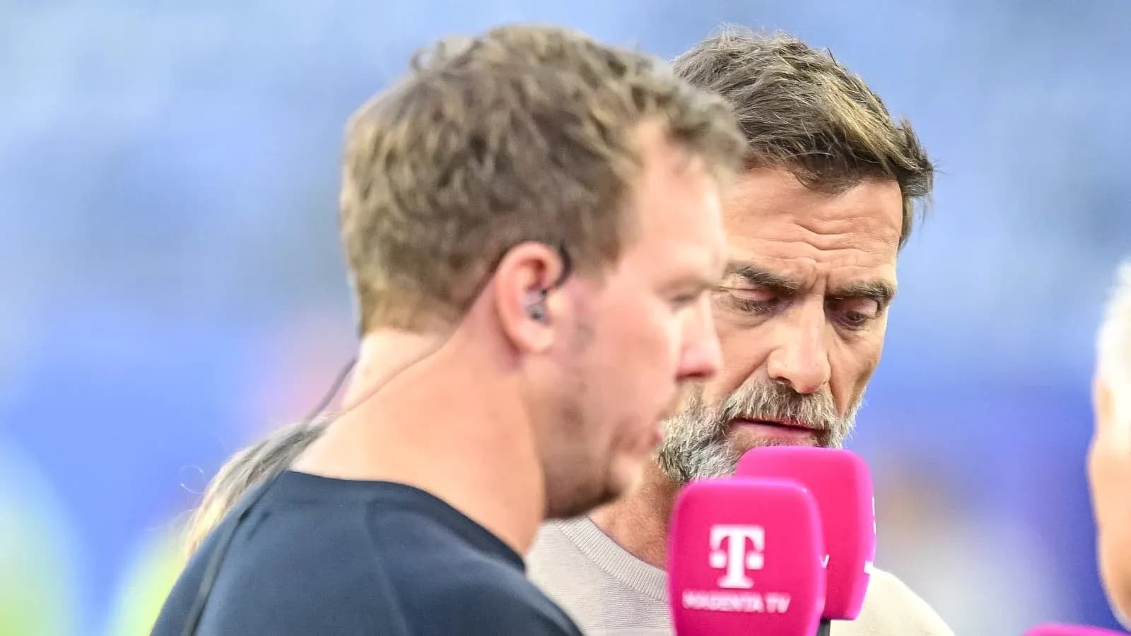 Two commentators speaking during a sports broadcast