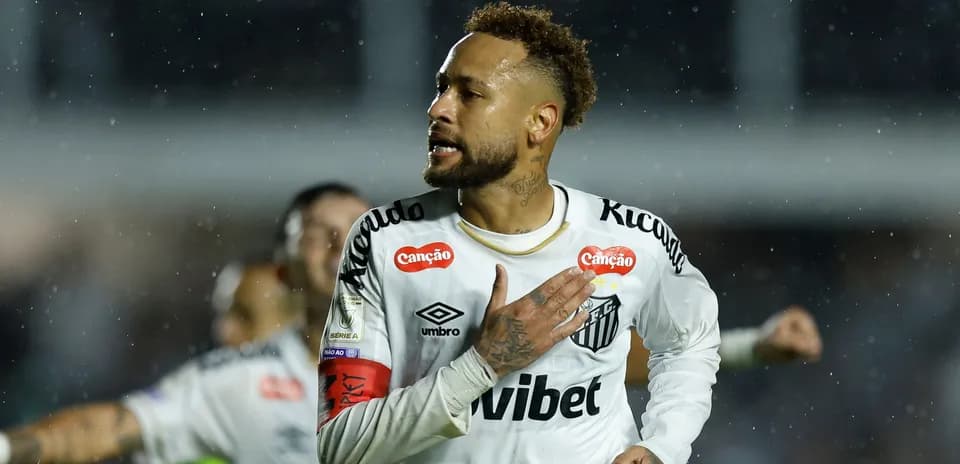 Player celebrating a goal in rainy match