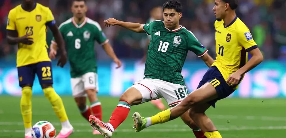 Mexico player challenges Ecuador player for the ball