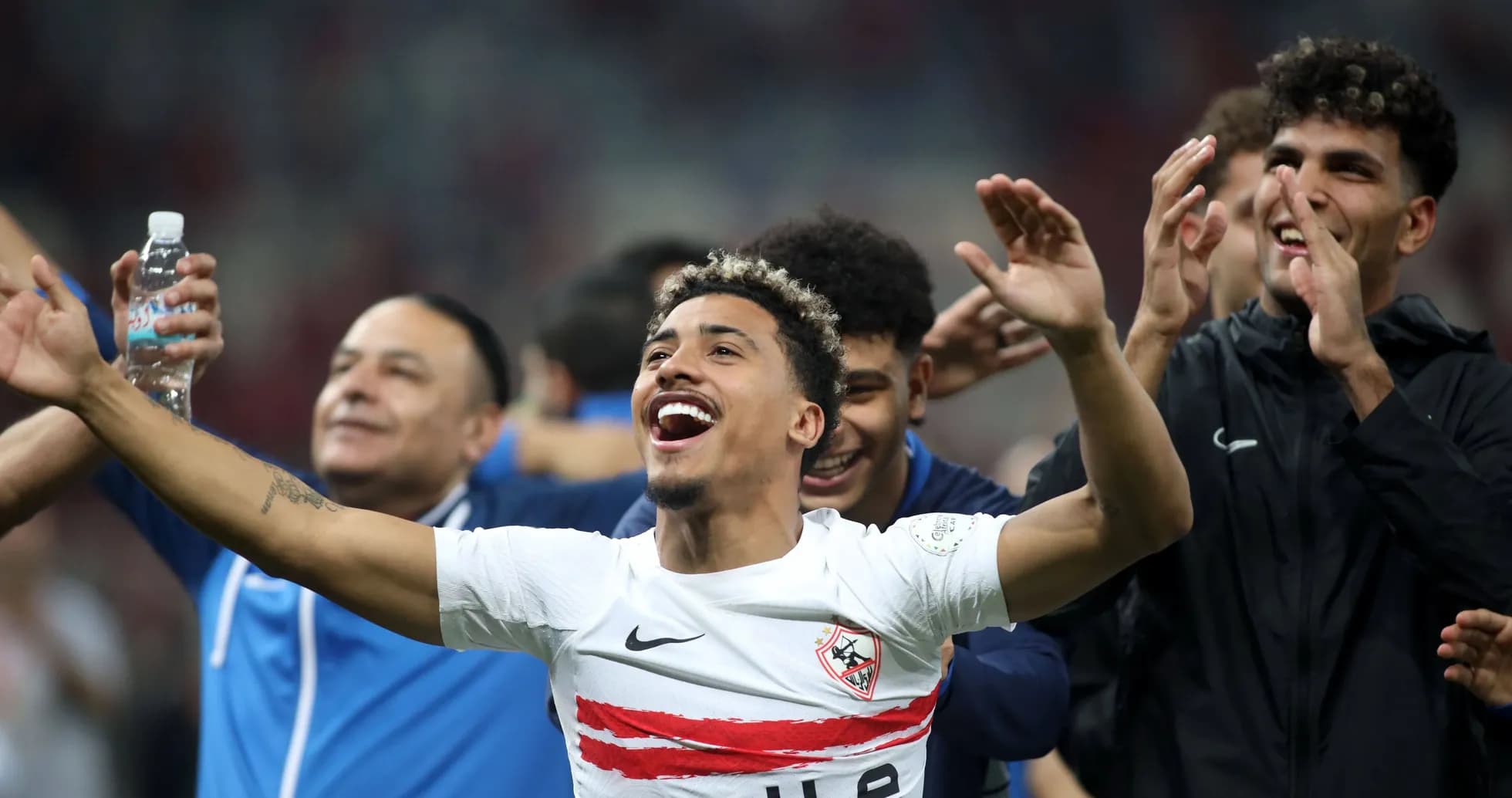 Players celebrating a victory on the field