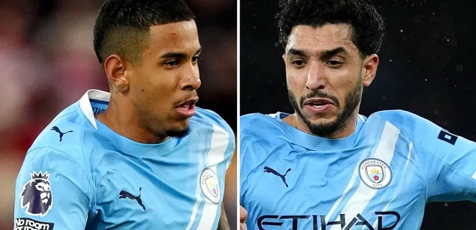 Two Manchester City players in blue kits during match