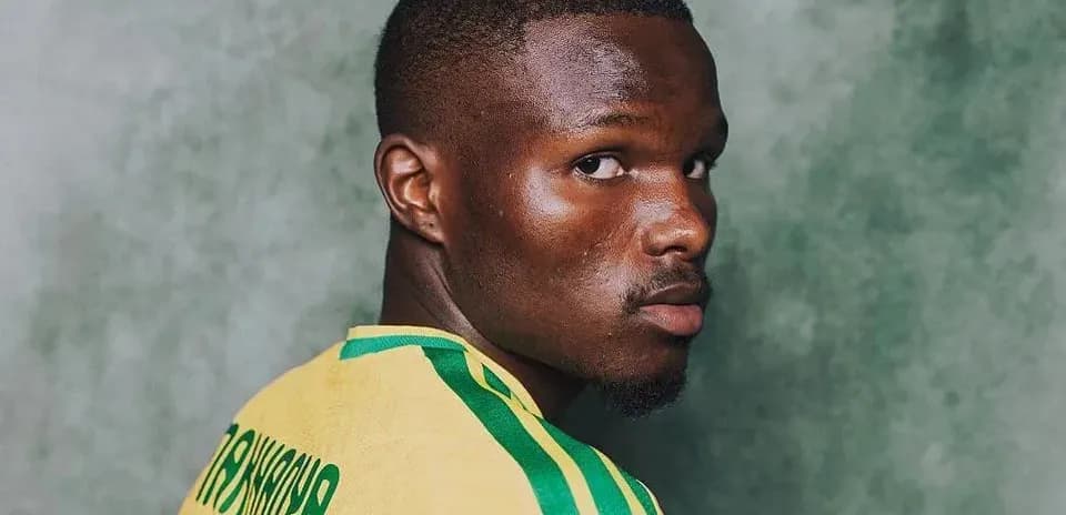 Player in yellow jersey looking back over shoulder