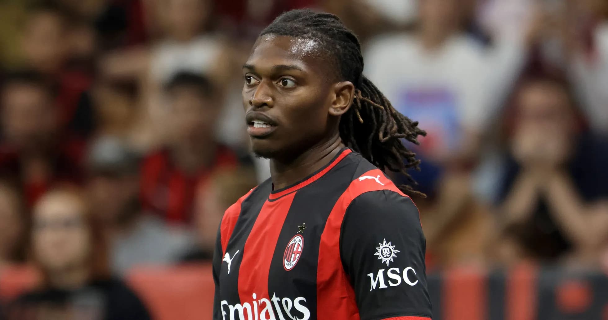 Player in AC Milan jersey on the field