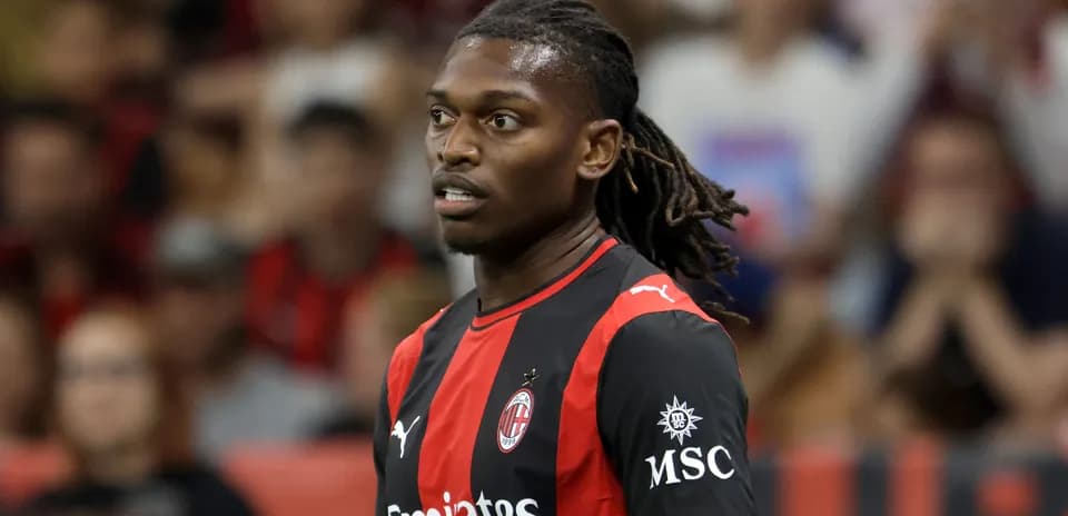 Player in AC Milan jersey on the field