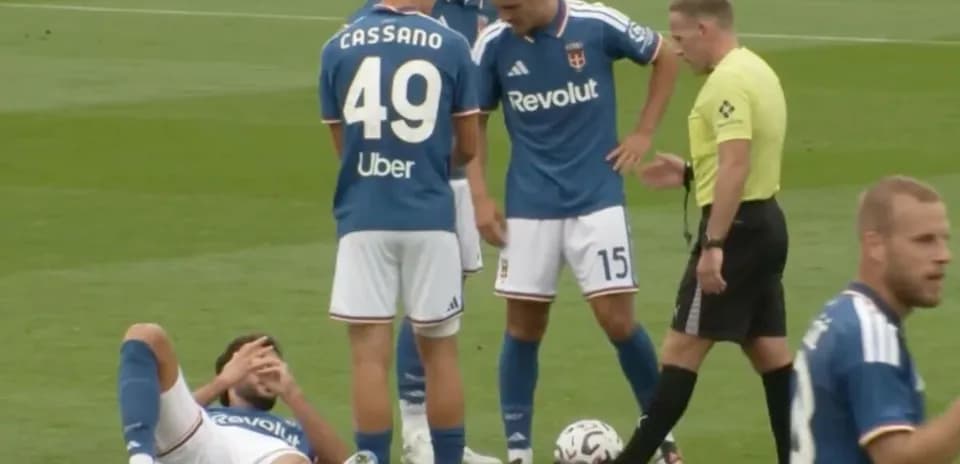 Players gathered around injured teammate on field